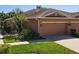 Charming front exterior features a well-maintained lawn, two-car garage, and a welcoming entrance at 4015 Bridlecrest Ln, Bradenton, FL 34209
