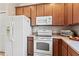 This kitchen features wooden cabinets, stainless steel appliances, and stone countertops at 4015 Bridlecrest Ln, Bradenton, FL 34209