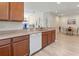 Bright kitchen features wooden cabinetry, stone countertops, stainless steel sink, and dining area at 4015 Bridlecrest Ln, Bradenton, FL 34209