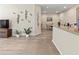 Open concept living room that leads into the dining area and features decorative wall art at 4015 Bridlecrest Ln, Bradenton, FL 34209