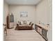Cozy living room featuring a loveseat, entertainment center, and light wood flooring at 4015 Bridlecrest Ln, Bradenton, FL 34209