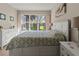 Comfortable main bedroom with a large window and outdoor views at 4015 Bridlecrest Ln, Bradenton, FL 34209