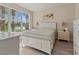 Inviting main bedroom featuring large windows with backyard and water views at 4015 Bridlecrest Ln, Bradenton, FL 34209