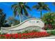 Elegant community sign surrounded by vibrant flowers, creating a welcoming entrance at 4015 Bridlecrest Ln, Bradenton, FL 34209