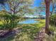 Serene water view of the lake and lush landscaping offers a tranquil escape from the backyard at 4015 Bridlecrest Ln, Bradenton, FL 34209