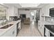 Bright kitchen featuring quartz countertops, stainless steel appliances and views to multiple rooms at 4099 Southwell Way, Sarasota, FL 34241