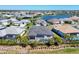 Aerial view of the home with screened in pool, green lawn, and a scenic water view at 4629 Antrim Dr, Sarasota, FL 34240