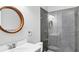 Bathroom featuring modern tiled shower, glass enclosure and wood trim mirror at 4629 Antrim Dr, Sarasota, FL 34240