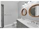 Bathroom featuring double sinks, a white counter top, and wooden mirrors at 4629 Antrim Dr, Sarasota, FL 34240