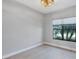 A bedroom with white walls and a window view to the lake at 4629 Antrim Dr, Sarasota, FL 34240