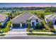 Stunning single-story home with a two-car garage, elegant landscaping, and a sprawling roofline against a scenic backdrop at 4629 Antrim Dr, Sarasota, FL 34240