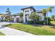 A stunning single Gathering house showcasing a three-car garage, vibrant greenery, and appealing architectural details at 4629 Antrim Dr, Sarasota, FL 34240