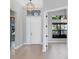 A welcoming foyer with light wood flooring, a stylish pendant light, and an airy atmosphere at 4629 Antrim Dr, Sarasota, FL 34240