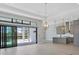 Bright, open kitchen with gray cabinetry, stainless steel appliances, and access to outdoor living space at 4629 Antrim Dr, Sarasota, FL 34240
