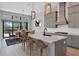 Eat-in kitchen with marble countertop island, gray cabinetry, stainless appliances, and sliding doors to outside at 4629 Antrim Dr, Sarasota, FL 34240