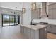 Modern kitchen featuring a large island, gray cabinetry, and stainless steel appliances at 4629 Antrim Dr, Sarasota, FL 34240