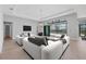 Airy living room with ample seating, stylish lighting, and access to a serene outdoor space via large glass doors at 4629 Antrim Dr, Sarasota, FL 34240