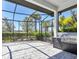 Covered patio with outdoor kitchen, grill, and screened enclosure offering a serene backyard view with lush landscaping at 4629 Antrim Dr, Sarasota, FL 34240