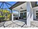 Covered patio with a built-in outdoor kitchen and screened enclosure, offering seamless indoor-outdoor living with lush landscaping at 4629 Antrim Dr, Sarasota, FL 34240