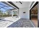 Covered patio with ceiling fan, tile flooring, exterior kitchen, and view of lush outdoor landscape, perfect for outdoor entertaining at 4629 Antrim Dr, Sarasota, FL 34240