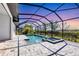 Inviting screened pool and spa with a spacious deck, perfect for outdoor entertaining and relaxation with lush landscaping at 4629 Antrim Dr, Sarasota, FL 34240