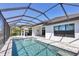 Inviting screened-in pool area with clear blue water, patio space, and summer kitchen for outdoor entertaining at 4629 Antrim Dr, Sarasota, FL 34240