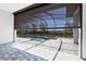 View of an enclosed swimming pool and outdoor patio, featuring modern design elements and a luxurious outdoor living space at 4629 Antrim Dr, Sarasota, FL 34240
