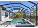 Screened in pool with tropical plants, offering a private and serene backyard retreat for relaxation and entertainment at 4629 Antrim Dr, Sarasota, FL 34240