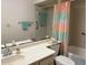 Clean bathroom featuring a spacious vanity, a large mirror, and a shower-tub combination at 4933 Village Gardens Dr # 211, Sarasota, FL 34234