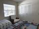 Bright bedroom features a relaxing sitting area, a closet and nautical themed decor at 4933 Village Gardens Dr # 211, Sarasota, FL 34234