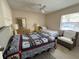 Comfortable guest bedroom with a full-size bed, a twin bed, chair and a relaxing decor at 4933 Village Gardens Dr # 211, Sarasota, FL 34234