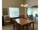 Dining room with wood table and chairs and sliding door to outside patio at 4933 Village Gardens Dr # 211, Sarasota, FL 34234