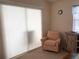 Cozy sitting area near a window with bright natural light and comfortable chair at 4933 Village Gardens Dr # 211, Sarasota, FL 34234