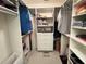 Well-organized walk-in closet with shelves, rods, drawers, and ample storage space at 4933 Village Gardens Dr # 211, Sarasota, FL 34234