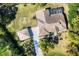 Aerial view of the home with a screened-in pool and detached garage at 4942 Hidden Oaks Ln, Sarasota, FL 34232