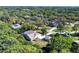 Aerial view of home showcasing mature landscaping and a screened-in pool at 4942 Hidden Oaks Ln, Sarasota, FL 34232