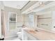 Bright bathroom featuring a bathtub and shower with an oversized vanity at 4942 Hidden Oaks Ln, Sarasota, FL 34232