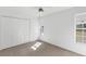 This bedroom offers a double closet, carpeted floors, and natural light from the window at 4942 Hidden Oaks Ln, Sarasota, FL 34232