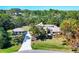 Sprawling home with an oversized driveway and lush landscaping at 4942 Hidden Oaks Ln, Sarasota, FL 34232