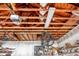 Well lit garage with high ceilings, wooden rafters, a garage door opener, and shelving for plenty of storage at 4942 Hidden Oaks Ln, Sarasota, FL 34232