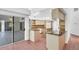 Light-filled kitchen featuring a tiled floor, granite counters and a sliding glass door at 4942 Hidden Oaks Ln, Sarasota, FL 34232