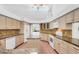 Bright kitchen with center island, light wood cabinets, and white appliances at 4942 Hidden Oaks Ln, Sarasota, FL 34232