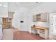 Kitchen featuring a breakfast bar and adjacent to built-in desk station at 4942 Hidden Oaks Ln, Sarasota, FL 34232