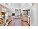 Spacious kitchen featuring a center island, white appliances, and breakfast bar at 4942 Hidden Oaks Ln, Sarasota, FL 34232