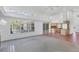 Bright living room featuring a fireplace, large windows, and an open layout leading to the kitchen at 4942 Hidden Oaks Ln, Sarasota, FL 34232