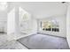 Open living space with vaulted ceilings, large windows, and decorative glass front door at 4942 Hidden Oaks Ln, Sarasota, FL 34232