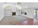 Inviting living area features a fireplace, built-in shelving, and plenty of natural light at 4942 Hidden Oaks Ln, Sarasota, FL 34232