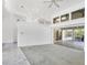 Bright living room featuring vaulted ceilings and access to screened outdoor patio at 4942 Hidden Oaks Ln, Sarasota, FL 34232