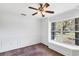 Sun-filled living room with ample natural light showcasing wainscoting and a large picture window at 4942 Hidden Oaks Ln, Sarasota, FL 34232