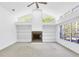 Large living area with a brick fireplace, built in shelves, and vaulted ceiling at 4942 Hidden Oaks Ln, Sarasota, FL 34232